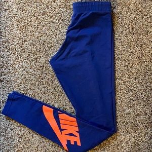 Blue nike leggings with orange nike left leg